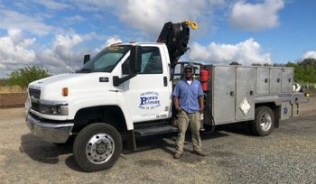 Man standing next to repair truck